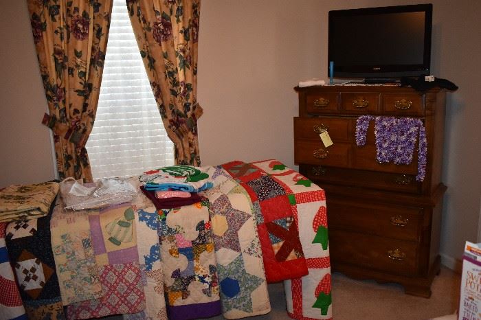 Just some of the many Quilts belonging to this Master Quilter and Collector of Quilts. These Quilts are in Excellent Condition and Absolutely Beautiful!!! Plus Chest that is part of the Bedroom Set and Flat Screen TV