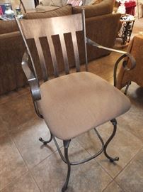 one of a pair of swivel bar stools
