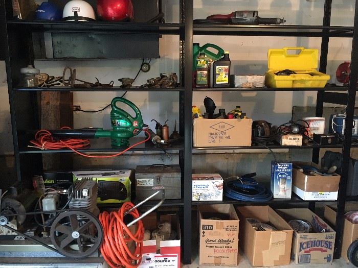 Shelves of garage stuff, including tools, compressor, supplies, helmets, and much more!
