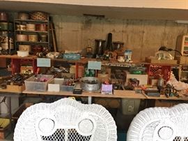 Detail on wicker furniture, table and shelved full of garage stuff!