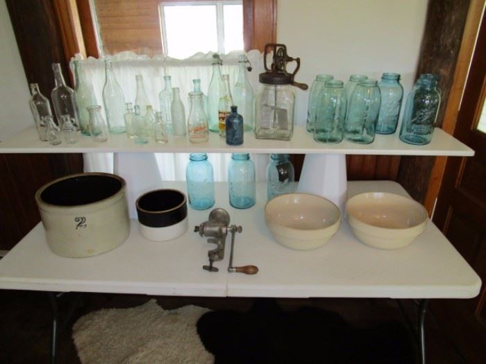 Antique bottles, some signed, Daisy butter churn, Ball canning jars, 2 gal butter crock, Stoneware shoulder bowls, Griswald meat grinder