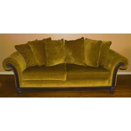 Bernhardt Furniture For Z Gallerie Sofa: A plush sofa from Bernhardt for Z Gallerie. The sofa features a loose pillow back and two seat cushions upholstered golden tan with brass tack trim accenting padded rolled arms and mahogany stained exposed front frame. The sofa rises on bun feet. Companion chair listed separately as item 17CIN384-015.