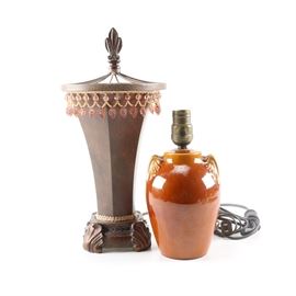 Decorative Lamps: An assembled pair of decorative lamps. The featured example was made in a stylized vase shape with beaded embellishments. The piece is accompanied by a brown glazed example with molded handles. Both lamps accommodate a single bulb.