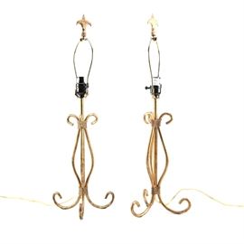 Brass Table Lamps: A pair of brass table lamps. These lamps feature three scrolled metal bands with a distressed finish. There are pointed finials and rotary switches.