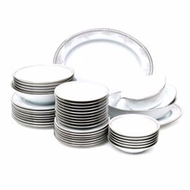 Noritake "Windham" Tableware: A set of Noritake Windham tableware. This set includes forty one pieces with a gray lattice band with white flower accents and a platinum trim. The base of each piece is marked “Contemporary Fine China by Noritake Philippines Windham”.