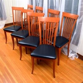 Eight Italian Dining Chairs by A. Sibau: A set of eight Italian-made dining chairs by A. Sibau. Each of these chairs features a maple frame with a straight crest and slatted back. Their vinyl seats rest on four slightly splayed legs. Two chairs feature simple arms while the rest are side chairs; they are marked with stickers to the underside.