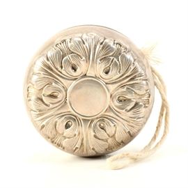 Gorham Sterling Plated Steel Yo-Yo: A vintage Gorham sterling plated steel yo-yo. This yo-yo features a sterling plated metal body with a raised floral motif and internally wrapped twine. The siding is marked “Gorham Sterling Cover 30 Steel Body.”