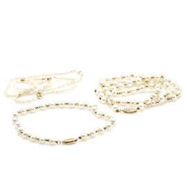 14K Yellow Gold Pearl Necklaces and Bracelet Set: A 14K yellow gold pearl necklaces and bracelet set. This includes two cultured freshwater pearl necklaces with gold spacing accents between the pearls and a matching bracelet.