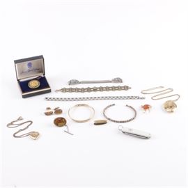 Vintage Jewelry Including a 1969 Kentucky Derby Pin: A collection of vintage jewelry and accessory items. Featured are a 1969 Kentucky Derby gold tone pin with green lacquer decoration in a presentation box, two gold tone lockets, a Southwestern style wristwatch band featuring chipped turquoise and coral, and an equestrian themed pin. Some items are gold filled. Also included, is a Swiss army multi-blade pocket knife in a white case.