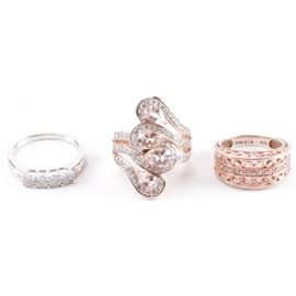 Sterling Silver Diamond and Morganite Rings: A selection of three sterling silver rings with morganite and 0.40 ctw diamonds. Features include a gold wash split shank morganite swirl ring, a silver tone cluster ring, and a rose gold wash openwork ring. Each piece is hallmarked or tested as sterling silver, and the total weight, inclusive of all materials, is 0.435 ozt.