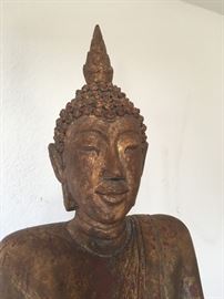 This is the peaceful face of a large walking Buddha that has been keeping us company