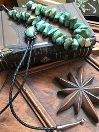 A couple of turquoise pieces on the top of a ships captain desk
