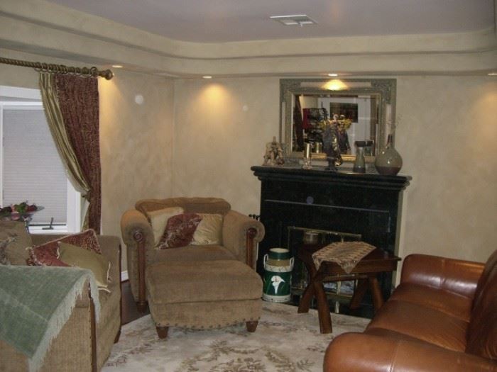 sofa chair; curtains and curtain rod;  rug;  mahogony side table;  decor items