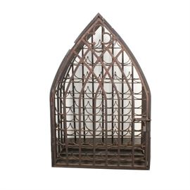 Iron Gothic Style Wine Rack: A Gothic style wine rack made of wrought iron. This rack features a pointed top with clover accents and cross-hatching. Inside the door are wine shelves. It is unmarked.