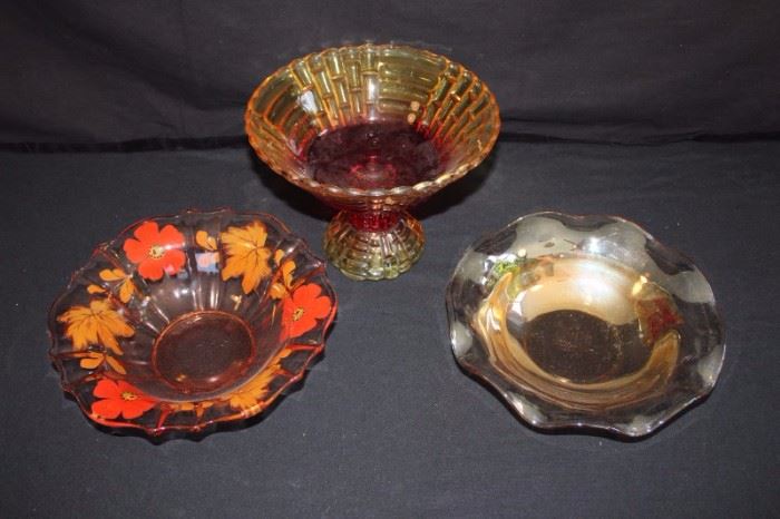 Various Amber Glass Bowls: one pedestal bowl 6-1/2" high with 9" diameter accented with red; 10" bowl with ruffle edges and 10" scalloped bowl with hand painted red flowers and fall leaves. (1920-40's). This lot is in very good condition and shows little wear, if any