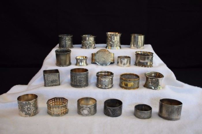 20-piece Victorian Napkin Ring Collection: (1840-1900) silver plated/electroplate and various metals 4 smaller and 16 average size. These are silverplated with some plate-through wear.All in good condition considering their age are very usable. Various shapes and sizes. No marks on inside, only marks on those with engraved design or initials and embossed decorations.
