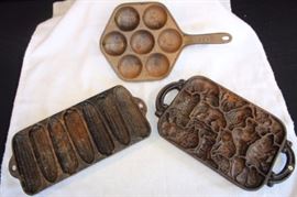 3 Cast Iron Baking Dishes Molds: B191984 signed "animal Puzzle Mold" 1984 John Wright; heavy 5 lbs. 3/4" thick x 13" x 7.5", Junior Krusty Korn Kobs Wagner Ware Sidney O #1319 Patented July 6, 1920 10.75 long x 7-3/8" wide x 1.785" high each bay 3.25" weighs 4.25 pounds, Jotul 7-well cast iron apple cake pan also used for popovers also called Aebleskiver No. 1 incised on the bottom of the handle is "Product of Norway", 12" x 7-3/8" 1.25" deep.  All are a bit rusted and need cleaning and seasonging.