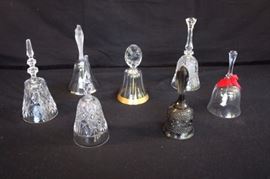 Collection of 7 Crystal & Glass Bells: Gold trimmed with "Partridge in a Pear Tree" handle, crystal bell with silver trim with Holy Family frosted handle, pressed glass with floral design, crystal bell with angel clap, grey pressed glass, crystal bell with etched rose design, crystal bell with geometric design made in Western Germany. This lot is in very good condition and shows little wear, if any - no chips, cracks or breaks.