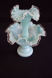 Light Aqua Fenton Epergne: This 2-piece vase was produced in the 1920’s and 1930’s. It is a great example of an elegant, yet affordable vase used during that time period. It is a beautiful light aqua color and is quite delicate with its ruffled edges; it is not marked. This vase will continue to give a lovely look to your table for many years. It is two pieces which together stands 10",  separately stands 6" & 8".  It is in mint condition and there are no chips or cracks in either piece.