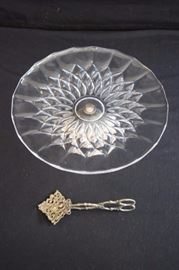 Val St. Lambert Cake Stand and Tongs.  The pattern is "Imperial" and the crystal plate is signed "VSL". The  cake plate is 12" in diameter, the silver plated base is 3" high and it stands 4" from 1950-60's.  The metal decorative Victorian serving tongs are 7". This lot is in very good condition and shows little wear, if any.Plate is This lot is in very good condition and shows little wear, if any. and tongs have a Victorian era patina.