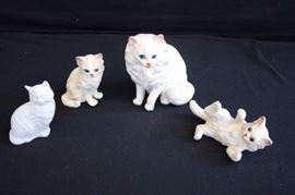 Trio of White Porcelain Cats & Avon Bottle: The ceramic cats are labelled and numbered. Mother cat is 5" and labeled "Norcrest Japan" marked A363; the playful cat is 2.5" labeled "Lefton Japan" marked 1513; third cat stands 3.5" marked 1513.  The white Avon cat perfume bottle is 3.5" high with label on bottom marked "Avon Somewhere Cologne, Keep out of reach of young children, 1.5 Fl. Oz, Avon Products Inc., N.Y, N.Y 10019." In very good condition no chips or cracks.
