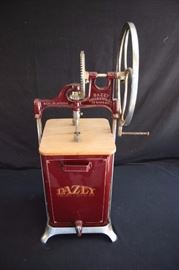 Dazey Commercial Metal Butter Churn;  Nicely restored butter churn from the early 1900's made by Daisy Churn & Mfg. Co.  It is marked on the face "Dazey Churn &  Mfg. Co." on the upper churn "Made in America DAZEY churn & mfg. co. St Louis MO." On the back "PATENTED 480B". The wooden paddles inside turns freely with two removable wooden lids.There are a few chips in the paint, otherwise in very good condition.