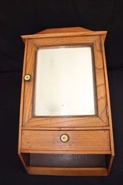 Oak Bathroom Medicine Cabinet w/bevelled mirror and drawer below:  It is 22"x14"x5" and from the 1940-60's. The bevelled mirro and wooden cabinet are in very good condition.