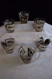 6 6 Oz Bar Glasses with 1900's Cars: These "Rocks" Old Fashioned Glasses are glass with gold, white and browndecorations depicting 1900 cars. This lot is in very good condition and shows little wear, if any.