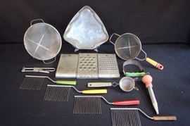 14-Piece Vintage Cooking Lot: 1) Three differently sized sifters: two with handles, one free standing. 2) Three differently sized cheese graters.  All stamped "The Wonder Shredder, Pat. No "1.768.462 and 1.768.463".  3) Four angel food cake cutters with multi-colored bake-lite handles.  4) Christmas tree cake pan, measures 10" x 9" x 1.25". 5) Aluminum turkey baster with red rubber bulb. 6) Bottle opener, stamped "Pat. No. 2000962" 7) Flour mixer with green handle. All have wear of paint and some natural age rust, but seem to be in very good vintage condition for their age and really show the true vintage feeling and time period. (Check out the photos!)
