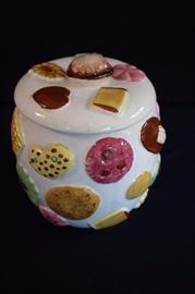 Vintage Cookie Jar:  Porcelain jar with lid features images of raised cookies, bottom stamped "C-3541" , made in Japan.  6.5" diameter, 7" height. This lot is in very good condition and shows little wear, if any.
