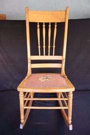Vintage Rocking Chair: Wooden chair with needlepoint seat cushion cover and spindled back.  38" height, 14.5" floor to seat, 16.5" wide, 15" seat depth.  Wood finish is in good condition and the seat cushion could use a little freshening up with new braiding/cording.