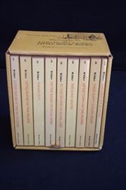 Boxed Set of Little House Books: includes 9 paperback books by Lara Ingalls Wilder, never been opened with cardboard housing.  "Little House in the Big Woods" J1, "Little House on the Prairie" J2, "Farmer Boy" J3, "On the Banks of Plum Creek" J4, "By the Shores of Silver Lake" J5, "The Long Winter " J6, "Little Town on the Prairie" J7, "These Happy Golden Years" J8, "The First Four Years" J31. In new condition; unread, unused books in perfect condition with no missing or damaged pages. 
