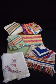 Multi-Cultural Linen Lot: Consisting of colorful Peruvian 37: x 34"table cloth with 4 matching napkins 10" x 11" and set if 4 coordinating napkins 10" x 12" , 6 colorful hand crocheted potholders 5.5" x 5.5", 3 handmade placemats 12" x 9.5"  and 1 tablecloth hand embroidered with Sun Bonnet Sue 33" x x 32". This lot is in very good condition and shows little wear, if any - no stains rips, or holes.