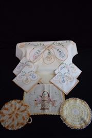 Yellow-Orange Vintage Luncheon Set: Tablecloth 35" x 35", 4 napkins 11.5" x 11.5" all with hand crocheted edges and hand embroidered with pastel flowers, 2 hand crocheted potholders 7" in diameter, Small table runner 10" x 16"with had crocheted edges  and hand embroidered basket of flowers. This lot is in very good condition and shows little wear, if any - no stains, rips or holes.