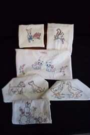 Hand Embroidered Dish Towels: 6 dish towels approximately 24" X 32" and each embroidered with a different animal: squirrels, dogs, bunnies, hens and ducks, kittens. Most are stained and would be nice to incorporate the handwork in a craft project.