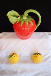 Ceramic Pitcher and Salt & Pepper: Strawberry shaped milk pitcher labeled with blue Made in Japan sticker and stamped 1983 8" tall and 8" from spout handle width, bright yellow lemon salt & pepper shakers 3" high. This lot is in very good condition and shows little wear, if any.