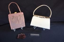 1940-50's Evening Purses: Lewis cream evening bag with gold and rhinestone snap closure, measures 10.25" at the bottom 6.5" from clasp to bottom with a 16" handle; light wear on outside with several small smudges; satin shows light wear also; Taupe satin evening bag measures 7.5" at bottom from clasp to bottom 9" with a 12" handle. Inside bag is a matching coin purse, mirror with Lewis insignia etched on it and small comb; small hardly noticeable snag on outside and satin  lining is in excellent condition