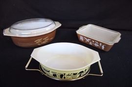Pyrex Casserole Dishes: 1) Covered Rectangle with ribbed lid marked "0503 1.5 quart Pyrex 27" measures 8.5" x 6.75". Lid marked "503-C Pyrex 33". 2) Oval shaped brown casserole dish with lid marked "045 Pyrex 5". Lid marked "945-C 15" measures 8.5" x 11". 3) Yellow casserole dish with metal holder marked "043 1.5 quart Pyrex" measures 7" x 8.5". This lot is in very good condition and shows little wear, if any. graphics in very good condition and there are no chips or cracks on any of the glass pieces