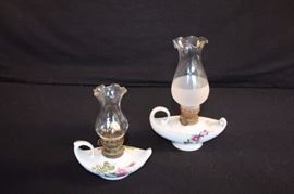 2 Vintage Aladdin's Lantern Oil Lamps: these beautiful oil lamps are decorated with pink roses and gilded with gold.  One lamp is 8" tall and 5.5" wide and labelled JAPAN on the bottom. The smaller lamp is lamp is 6" tall  and 4.5" wide and the collar is marked Made in Hong Kong. The collars and the burners are in good shape and the wick raiser is in good working condition. There are no cracks or chips in the glass.
