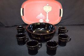 Tom & Jerry Punch Set with Tray: the set is black with gold trim and includes a 9.5" x 4.5" punch bowl which holds 2 + quarts and six 5 ounce cups all stamped JAPAN on the bottom.  There are no cracks or chips. The oval red tray fiberglass serving tray is 18" x 12" with stylized hand painted lamps = Eames Era Modern Tableware GRP era (glass reinforced polyester) with bamboo-like handles. This lot is in very good condition and shows little wear, if any - no chips or cracks on punch .