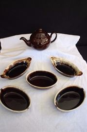 Brown Pottery Lot:  teapot marked Made in England; three 7.75" x 5.25" "Brown Drip" Cassoulets marked 21 York Gourmet Ware USA Ovenproof; two 9.5" x 4.75" "Brown Drip" Cassoulets marked PFALTZGRAFF with logo U.S.A. 265. This lot is in very good condition and shows little wear, if any - no chips or cracks
