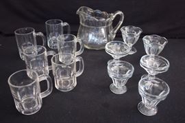 13 Piece Ice Cream Parlor Set:  all clear glass, one 2 quart pitcher 6.5" tall, four Hazel Atlas 8 ounce 3.75" mugs; two 12 ounce 4.5" mugs, two one-scoop ice cream dishes 3" diameter 3" high,  two one-scoop ice cream dishes 3.5" diameter x 3"; 2 two two-scoop ice cream dishes 3.5" diameter x 3.75" high. This lot is in very good condition and shows little wear, if any - no chips or cracks
