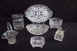 7 Heavy Cut Glass Lead Crystal Lot: 13.5" x  8.5" oval relish serving dish with handles and 5 sections with peacock feather eye;  8.5" x 6" x 3"oval serving dish with criss-cross design; one 6" round  footed shallow vase 4" high with butterfly design; 4" square footed ashtray with etched frosted roses; 7" small basket vase/candy dish with etched frosted roses; 5" diameter x 6" x 6" tall vase; very old "squarish" jelly/condiment dish with lid and spoon 5" high, 2.5" at base. This lot is in very good condition and shows little wear, if any - no chips or cracks