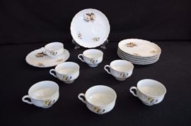 Porcelain China Luncheon Set: seven 10 ounce cups and seven 8" dessert plates hand painted with flowers in tones of blue, rose and gold all with gold rim; marked JAPAN. This lot is in very good condition and shows little wear, if any - no chips or cracks.