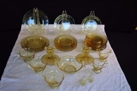 Yellow Depression Glass: Early 1930's 34-piece Madrid entertaining set including  a pair of Corinthian candlesticks (4")  candy dish (5.5") mini salt & pepper shakers (2"), creamer (3"), sugar (2.5"), 11 saucers (6"), 8 dessert plates (6"), 5 salad plates (7.5") 3 4 ounce coffee/tea cups  (3.5") all plates are dodecagon or 12-gon sides (12 sided) probably by Tiffin, Heisey or Cambridge. Very good vintage condition - No chips, cracks, or deep scratching. As with all vintage items, some slight surface scratches can be seen on the tops of the plates from utensil use and some on the bottom from stacking . and the glass is bright and clear. No staining or discoloration.