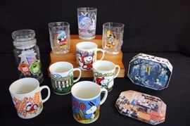 1980's Cartoon Character Collection:  5 Snoopy Mugs (10 ounces) (3.5") © 1958,1965 all stamped on bottom PEANUTS Characters: United Feature Syndicate, Inc: Jogging, Chicago, Texas (Made in Japan paper sticker), New Orleans, Washington D.C.; 2 square round 16 ounce Mickey Mouse glasses (4.5") Commemorating 2000 Walt Disney World 2000; Fantasia Mickey (20 ounces) (5") "Remember the Magic" Walt Disney World; 8" covered M&M canister commemorating the Games of XXIIIrd Olympiad Los Angeles California 1974; Walt Disney's One Hundred and One Dalmatians Commemorative Pin Set with six lapel pins. This lot is in very good condition and shows little wear, if any - no chips or cracks in glass pieces.