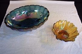 Carnival Glass: iridescent gold-toned small serving bowl (7.25" in diameter 2.75" high) with scalloped edges and a stylized daisy on bottom of the bowl; iridescent blue-grey oval footed serving bowl (12" x 8.5" x 4.5"). This lot is in very good condition and shows little wear, if any - no chips or cracks.