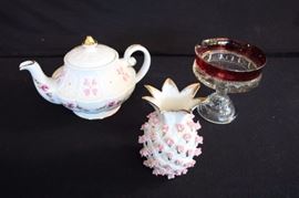 "In the Pink" Lot: Genuine Ironstone Ellgreave 1 quart teapot made in England, numbered 1069 and marked on the bottom with ELLGREAVE logo Ralph 1750 Moses 1751 Enoch 1784 A Div. of Wood & Sons is 9.25" from handle to spout, 6" wide, 6" tall;  round candy dish with cranberry glass rim and pressed thumbprint clear pressed glass bowl and pedestal, it is 5" diameter, 5.25" high,; decorator pineapple shaped vase  with gold edges and accents decorated with sweet little pink rosebuds it is 3.5" diameter, 5.25" high. This lot is in very good condition and shows little wear, if any - no chips or cracks.