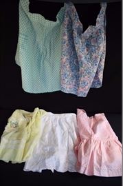 Pastel Vintage Handmade Apron Lot II:  5 aprons all in good vintage condition; floral blue-swirl trimmed with pin and blue rick-rack / no pocket;`yellow dotted swiss trimmed with lace and heart-shaped pocket; pink and white polka dot fabric with pink, white & gold trim/ with 2 pockets; light aqua gingham with rushing and trimmed with aqua rick rack with one pocket; all white Battenberg fabric with one pocket. All in good vintage condition, no rips, stains or holes.
