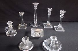 Very Old & Vintage Clear Candlesticks: 8" art deco pair with 3.5" base; very old (beginning to turn purple) 9.75" single candlestick with 4.5" base; very old squared 6.5" single with 3.25" square base; vintage 4.5" chamber candlestick with 3.5" octagonal base; 3" chamber candlestick with 5.5" round base; 2.5" candlestick with 4.25" round base; 1.25" art deco candlestick with 4.25" square base. All This lot is in very good condition and shows little wear, if any -  no chips or cracks